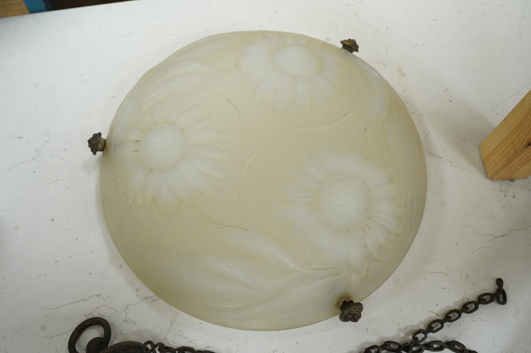 A Lalique style opalescent glass ceiling shade decorated with three sunflowers, 34cm in diameter
